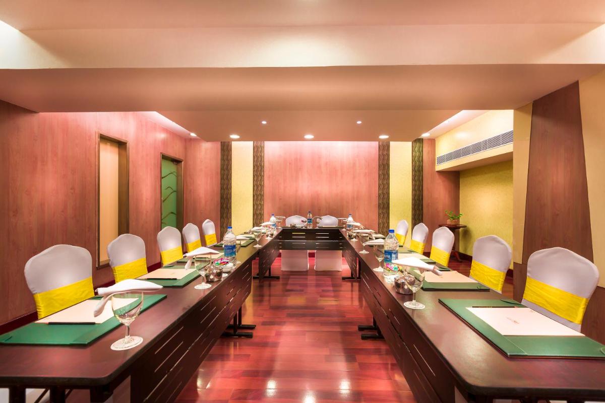 a large long table in a room with chairs at Grand Chennai by GRT Hotels in Chennai