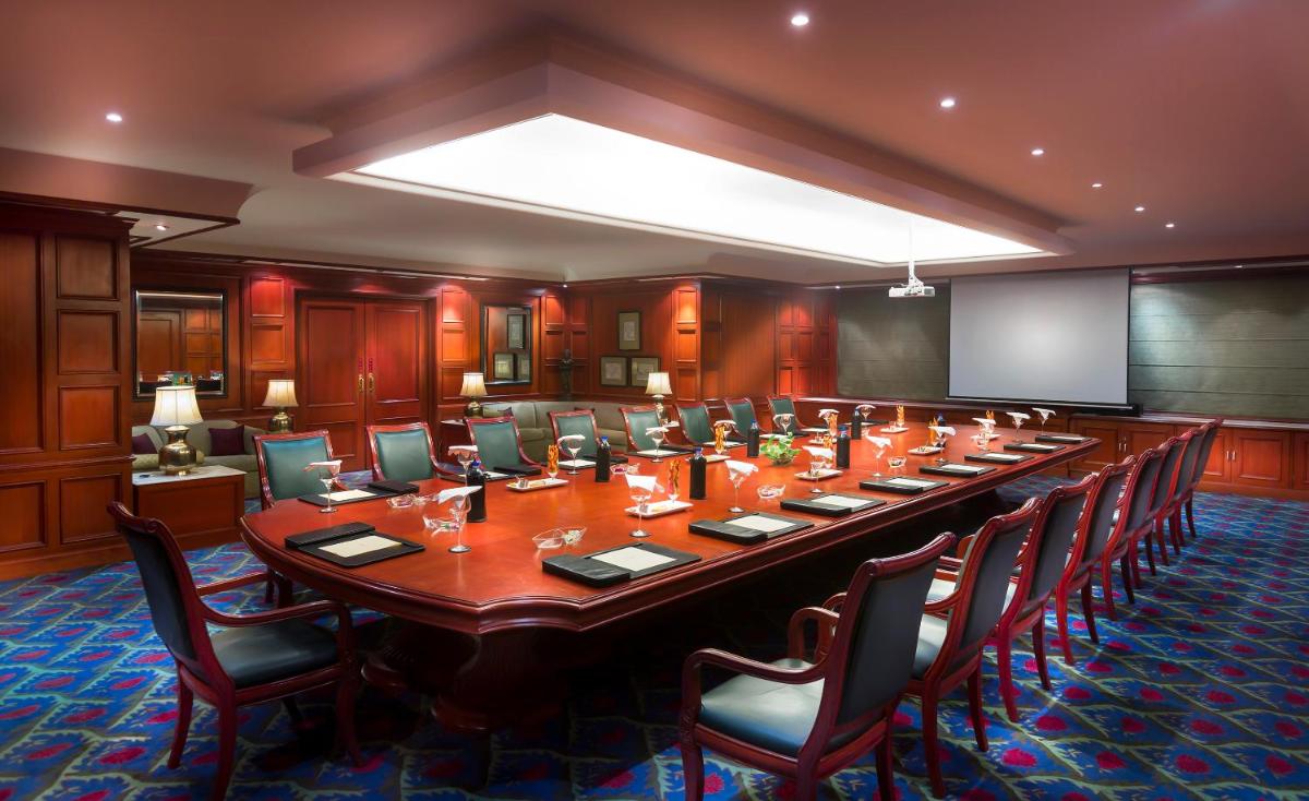 a large conference room with a long table and chairs at Grand Chennai by GRT Hotels in Chennai