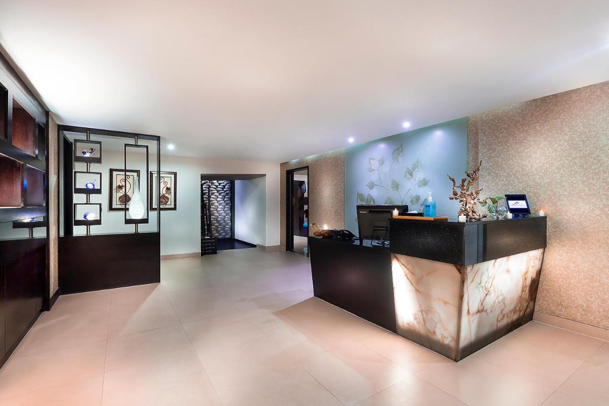 a lobby of a hotel with a reception desk at Grand Chennai by GRT Hotels in Chennai