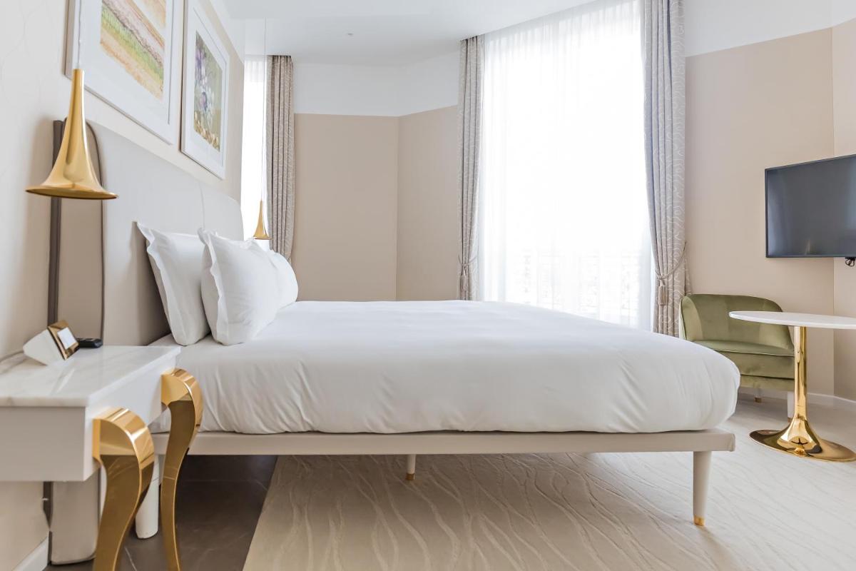 Un ou plusieurs lits dans un hébergement de l'établissement Boscolo Lyon Hotel & Spa