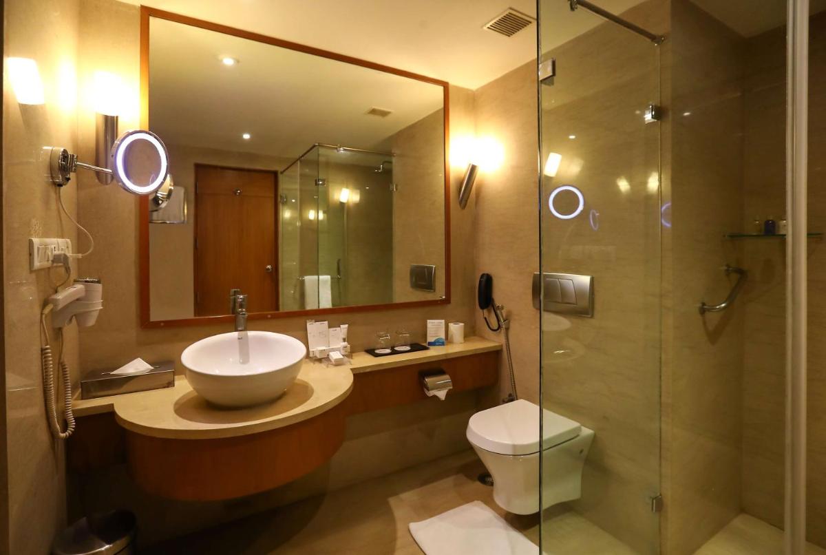 a bathroom with a sink and a toilet and a shower at Radisson Blu Hotel Chennai City Centre in Chennai a bathroom with a sink and a toilet and a shower at Radisson Blu Hotel Chennai City Centre in Chennai