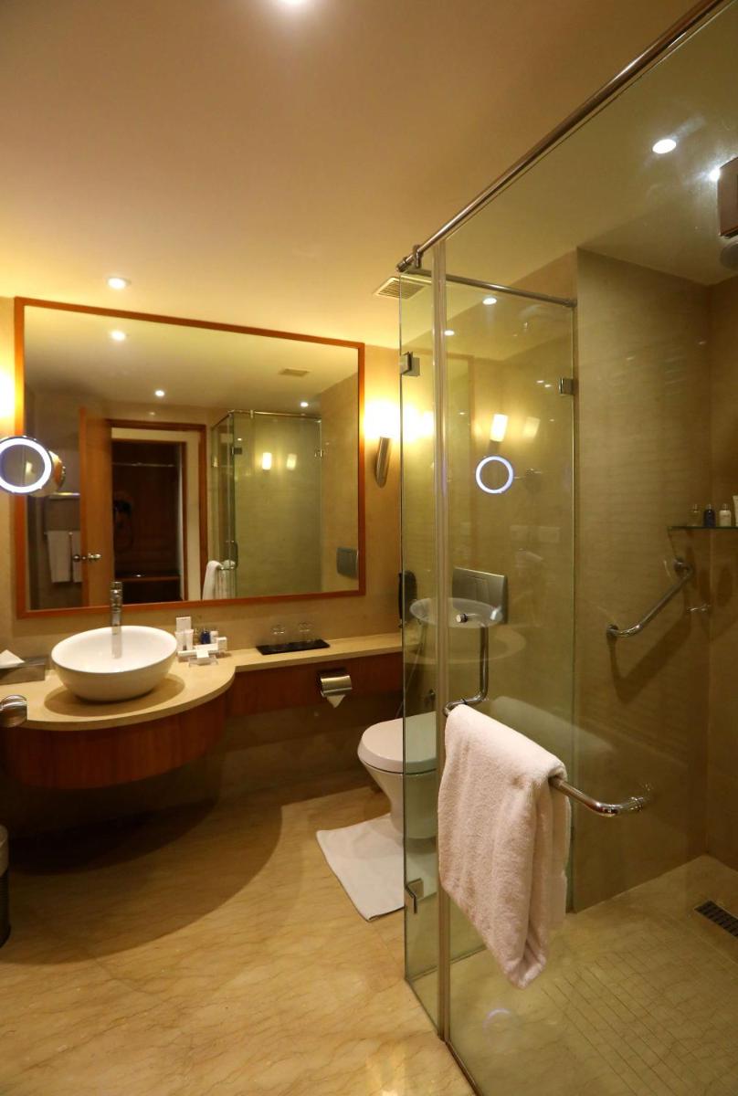 a bathroom with a sink and a toilet and a shower at Radisson Blu Hotel Chennai City Centre in Chennai a bathroom with a sink and a toilet and a shower at Radisson Blu Hotel Chennai City Centre in Chennai