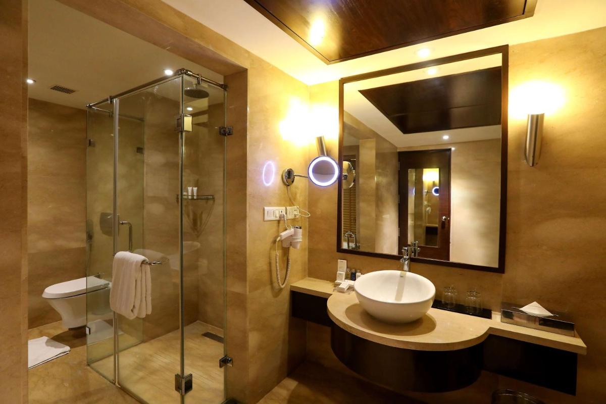 a bathroom with a sink and a shower at Radisson Blu Hotel Chennai City Centre in Chennai a bathroom with a sink and a shower at Radisson Blu Hotel Chennai City Centre in Chennai