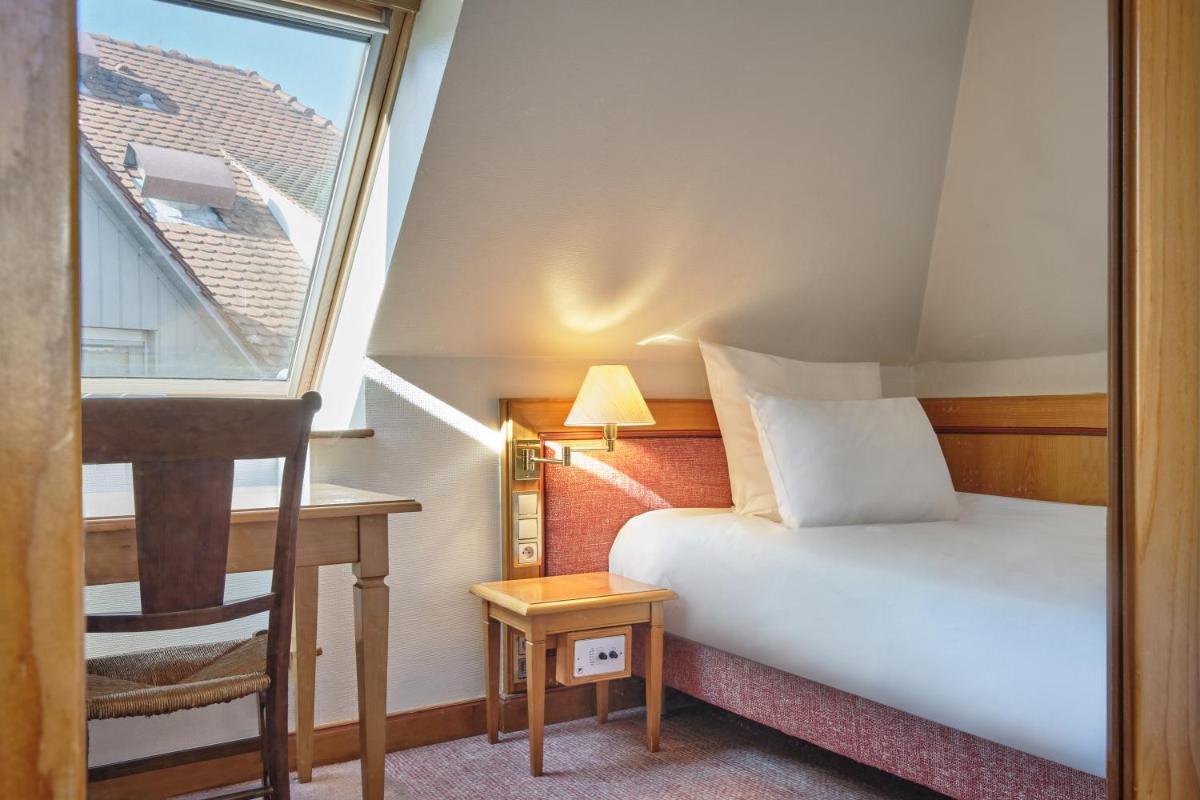 Un ou plusieurs lits dans un hébergement de l'établissement Hotel & Spa A la cour d'Alsace by HappyCulture