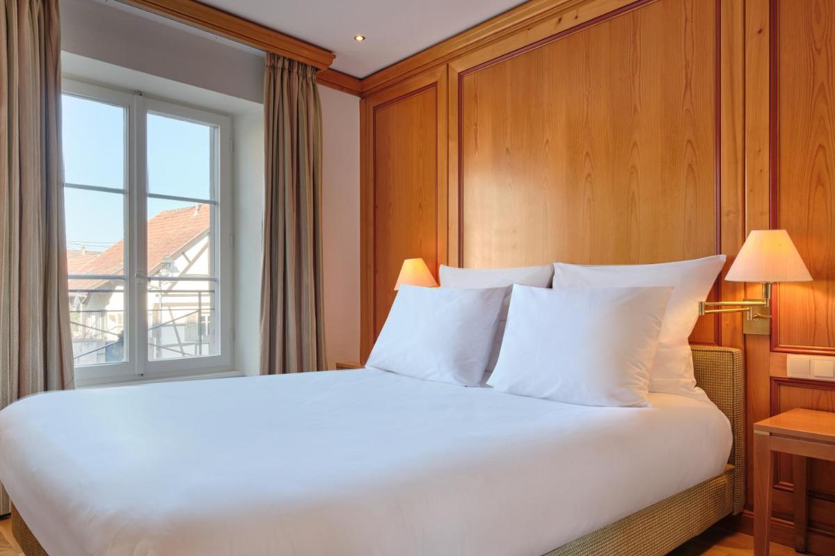Un ou plusieurs lits dans un hébergement de l'établissement Hotel & Spa A la cour d'Alsace by HappyCulture