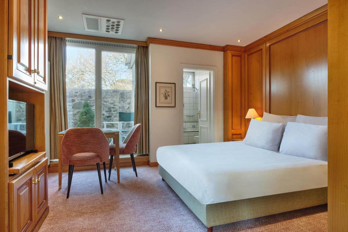 Un ou plusieurs lits dans un hébergement de l'établissement Hotel & Spa A la cour d'Alsace by HappyCulture