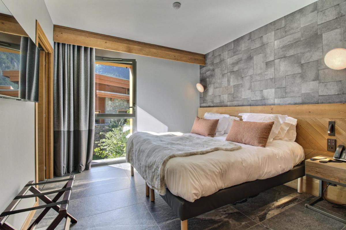 Un ou plusieurs lits dans un hébergement de l'établissement Pure Montagne Resort & Spa