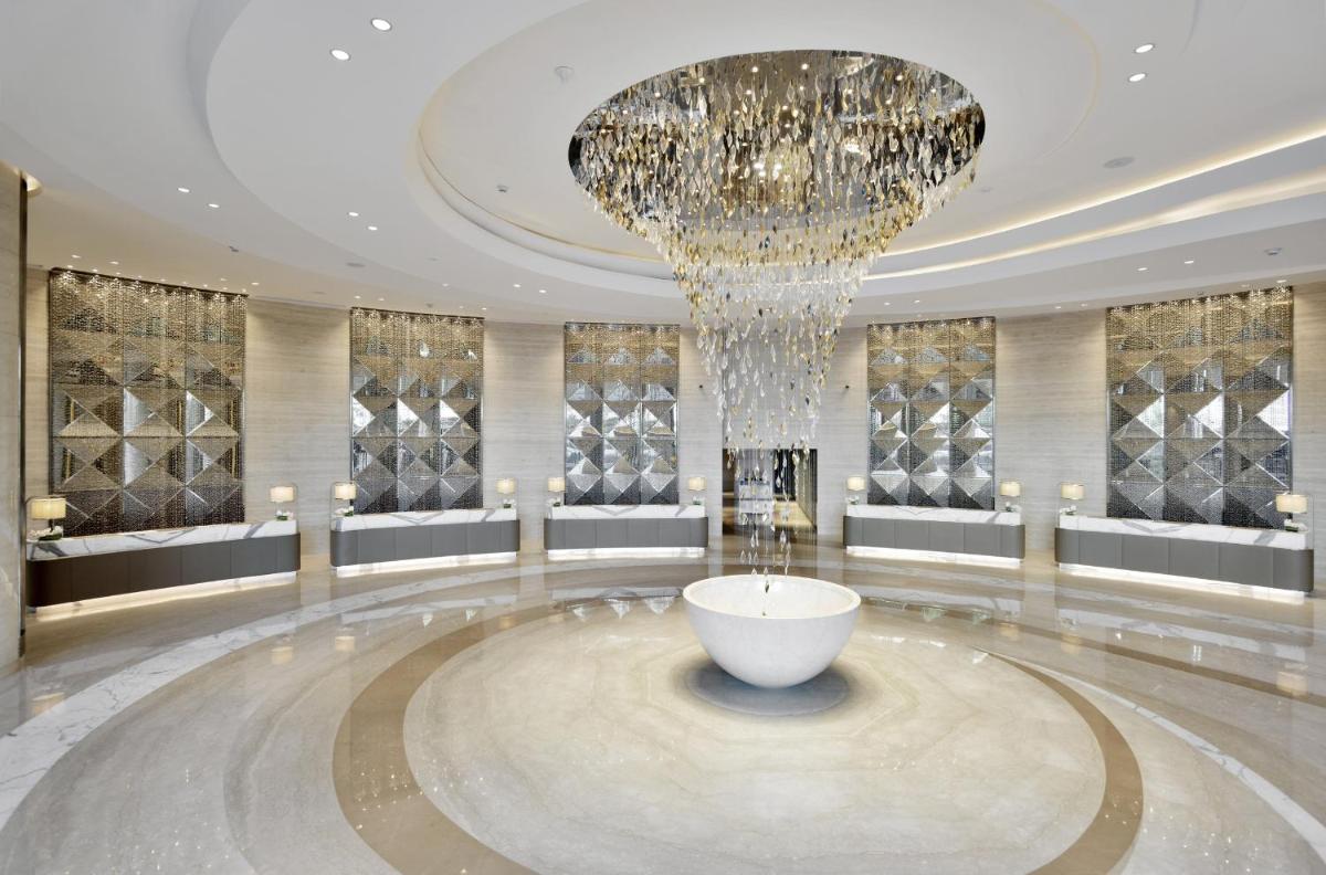 a lobby with a large chandelier and a large bowl at JW Marriott Mumbai Sahar Airport in Mumbai a lobby with a large chandelier and a large bowl at JW Marriott Mumbai Sahar Airport in Mumbai