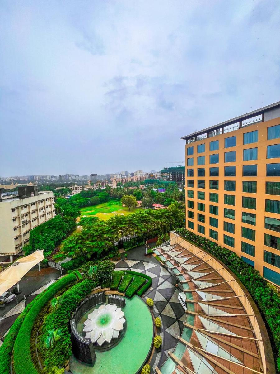 an overhead view of a park with a building at JW Marriott Mumbai Sahar Airport in Mumbai an overhead view of a park with a building at JW Marriott Mumbai Sahar Airport in Mumbai