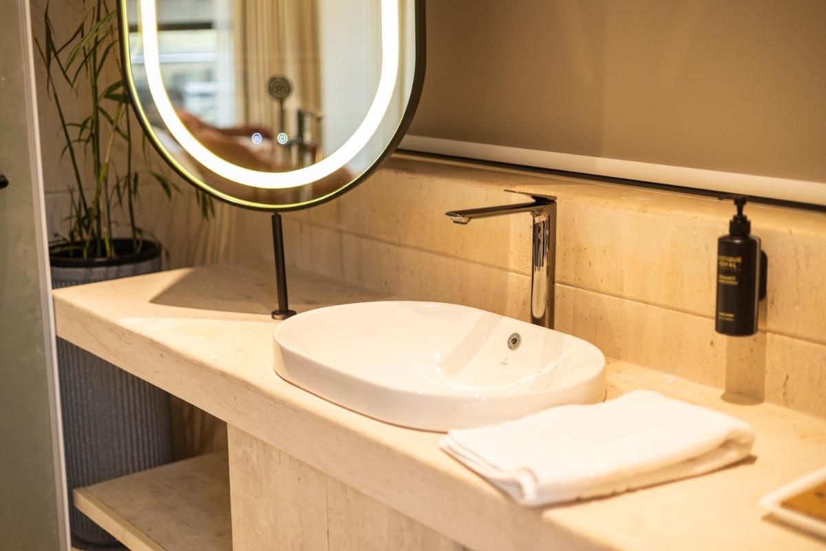 a bathroom with a sink and a mirror at Antalya By Divine Ganga Cottage in Rishīkesh