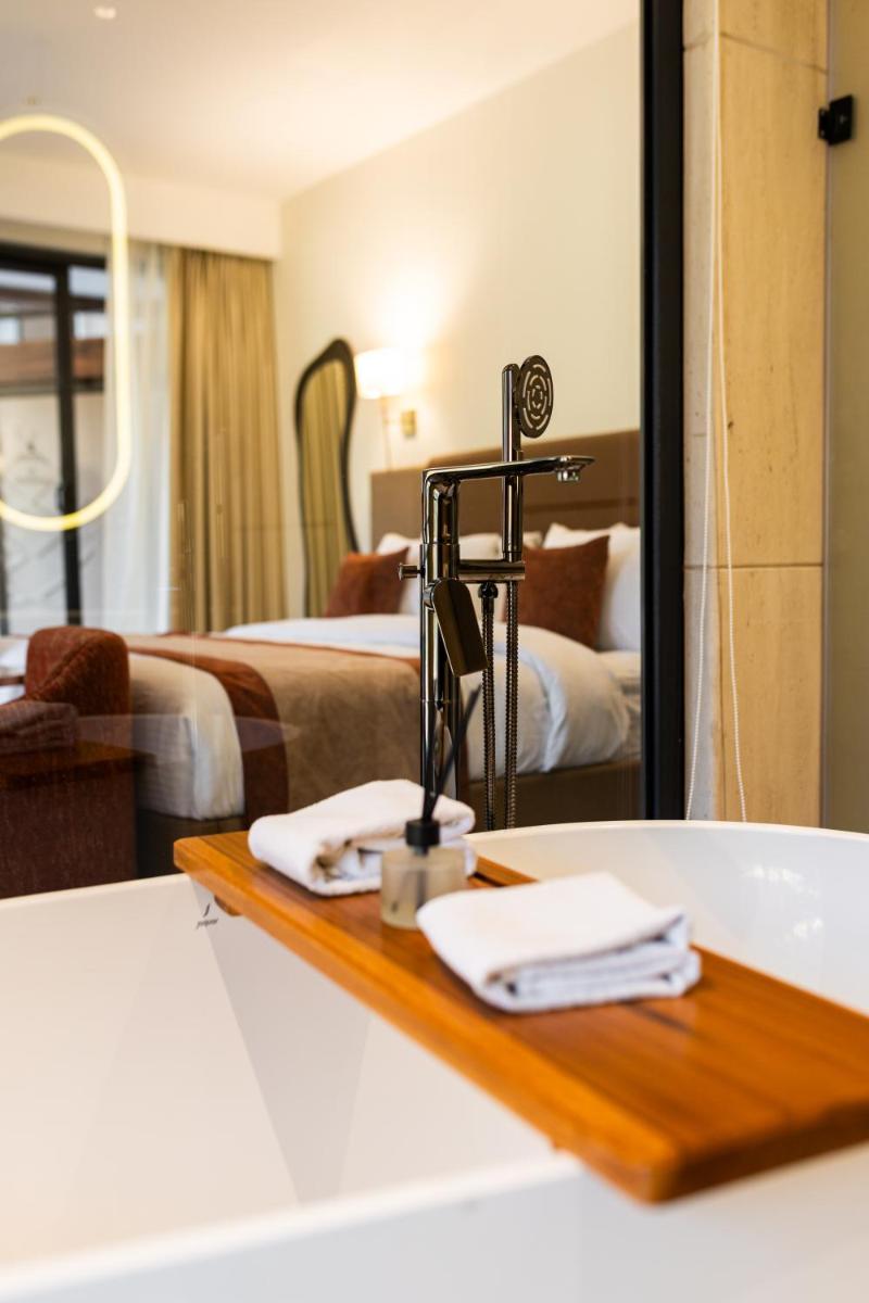 a bathroom with two beds and a sink and a mirror at Antalya By Divine Ganga Cottage in Rishīkesh