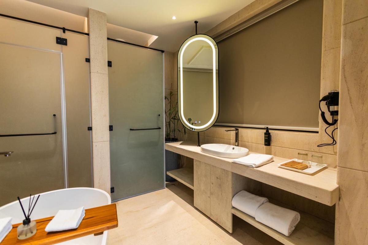 a bathroom with a sink and a mirror at Antalya By Divine Ganga Cottage in Rishīkesh