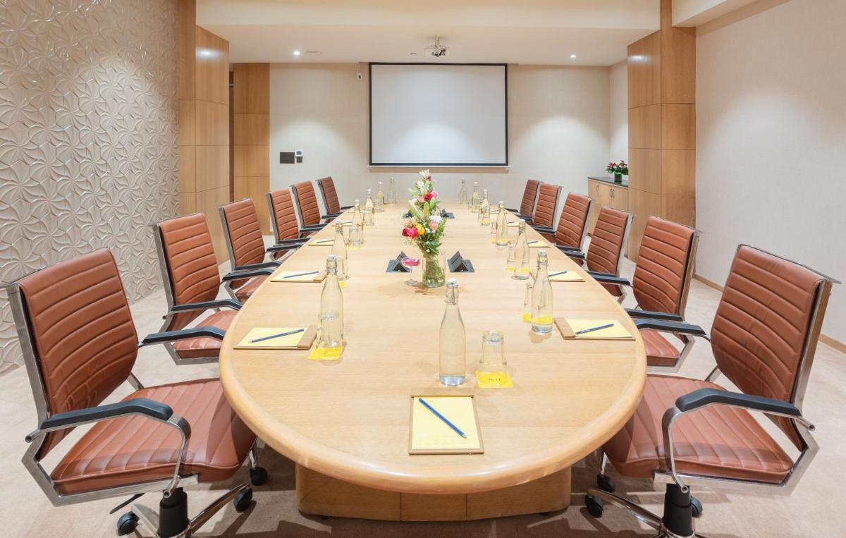 a large conference room with a long table and chairs at Golden Tulip Jaipur in Jaipur