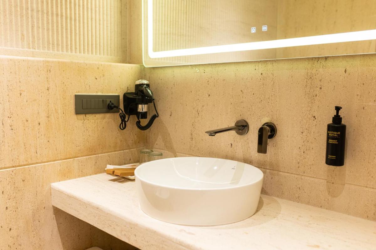a bathroom with a white sink on a counter at Antalya By Divine Ganga Cottage in Rishīkesh