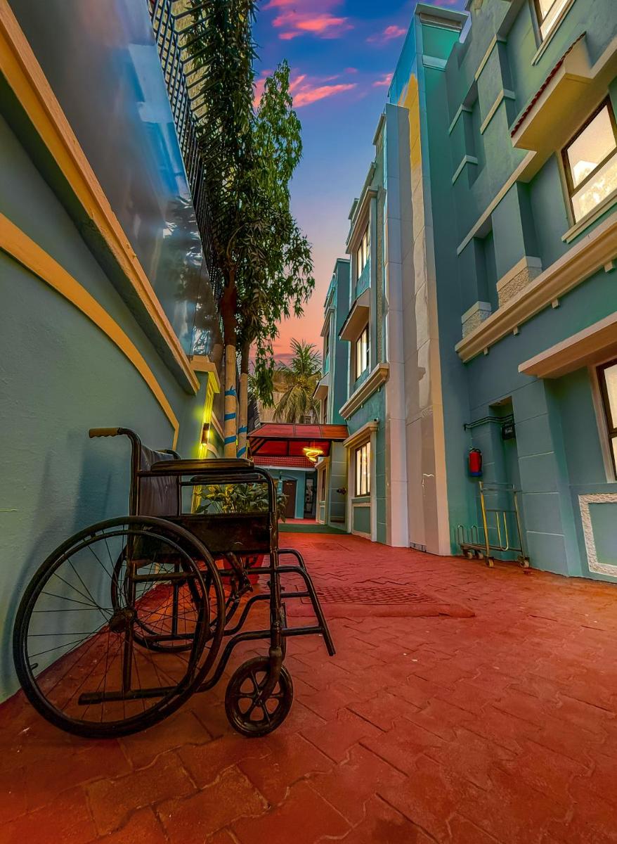 a bike sitting on a brick walkway next to a building at MyOtel - Santacruz in Mumbai