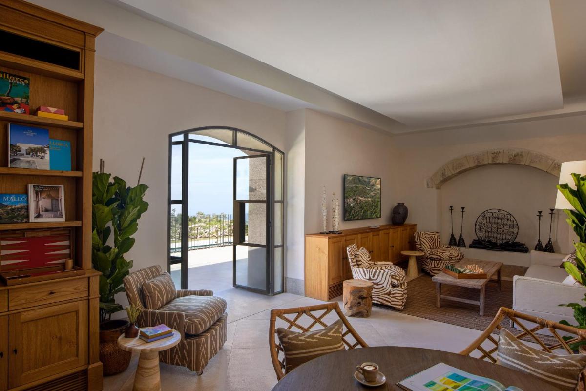 una sala de estar con una mesa y sillas en Son Bunyola Resort and Villas, en Banyalbufar