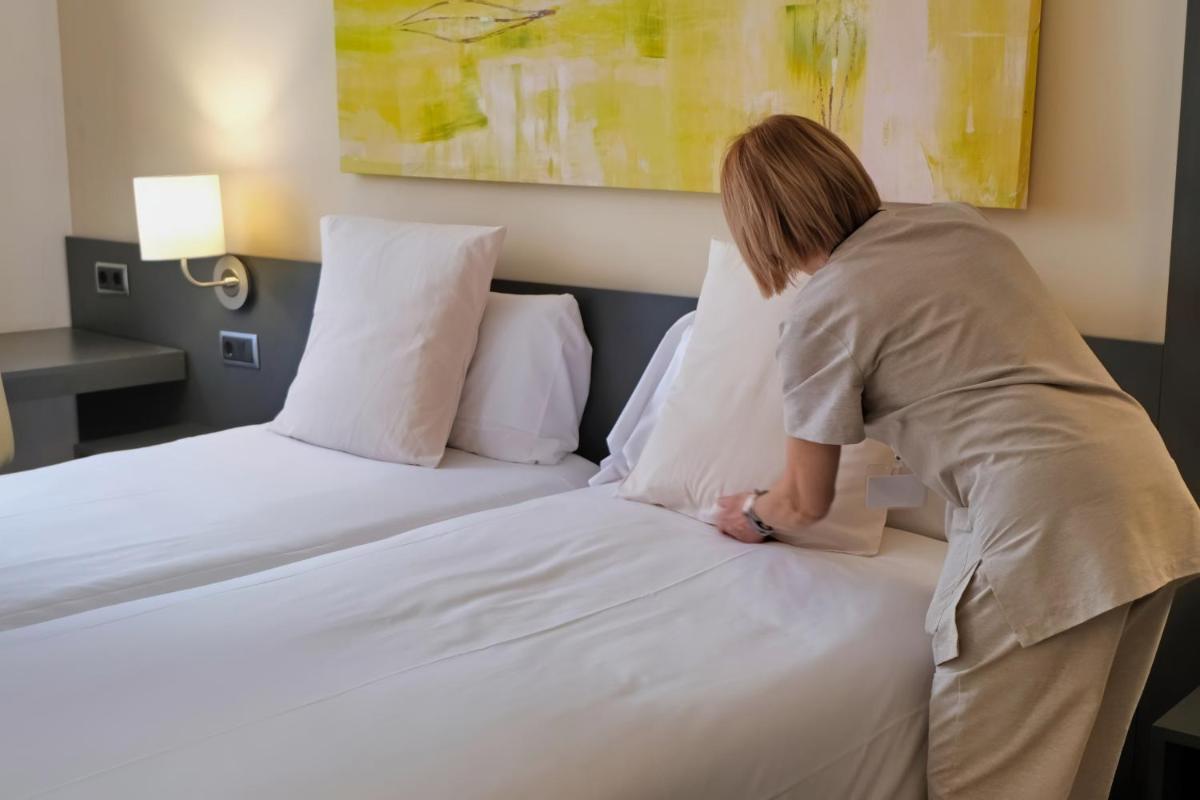 Cama o camas de una habitación en Hotel Marina