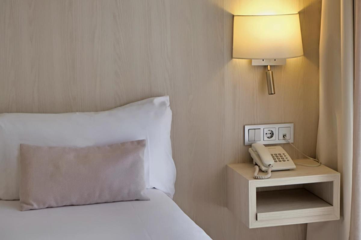 Cama o camas de una habitación en Hotel Marina