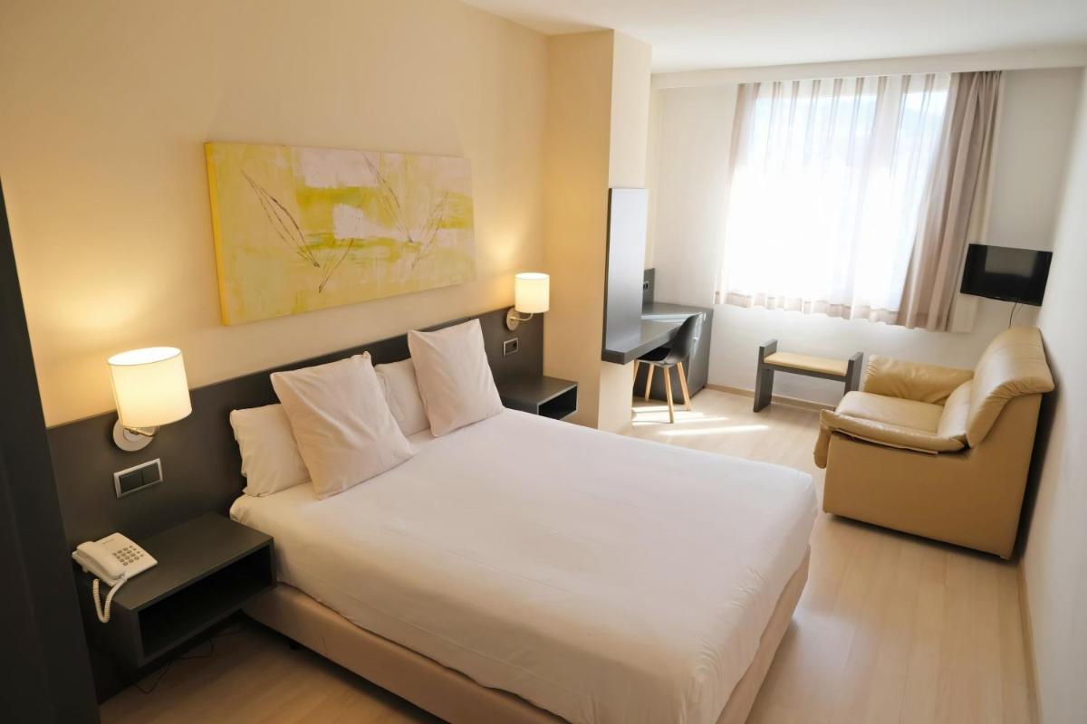 Cama o camas de una habitación en Hotel Marina
