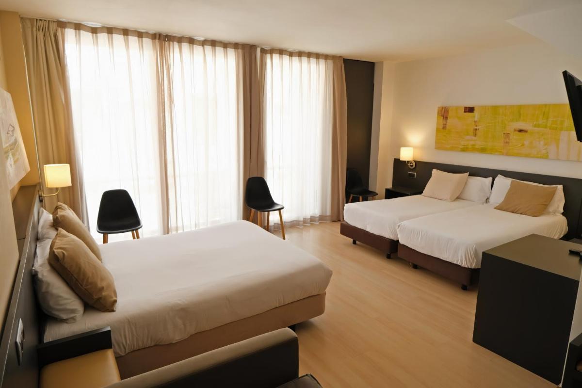 Cama o camas de una habitación en Hotel Marina
