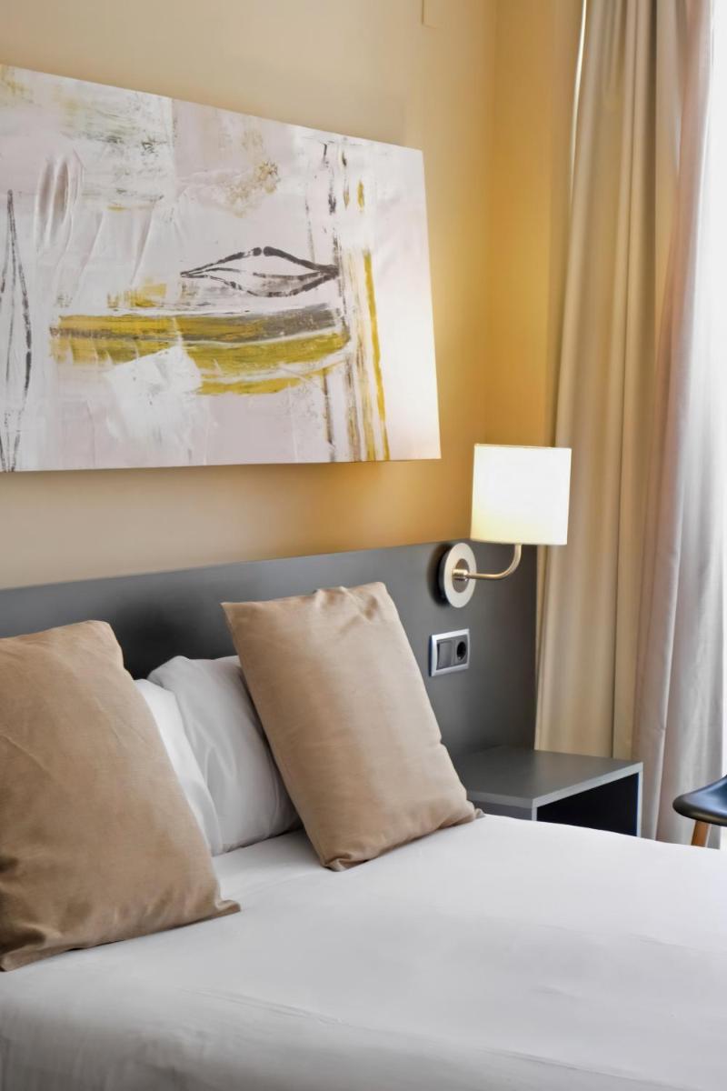 Cama o camas de una habitación en Hotel Marina