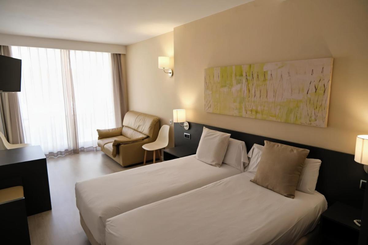 Cama o camas de una habitación en Hotel Marina