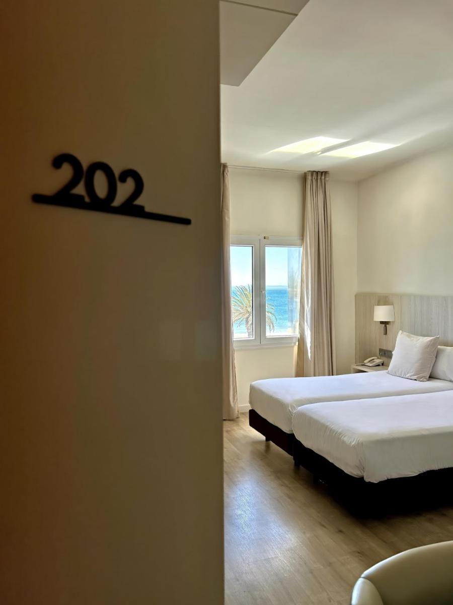 Cama o camas de una habitación en Hotel Marina
