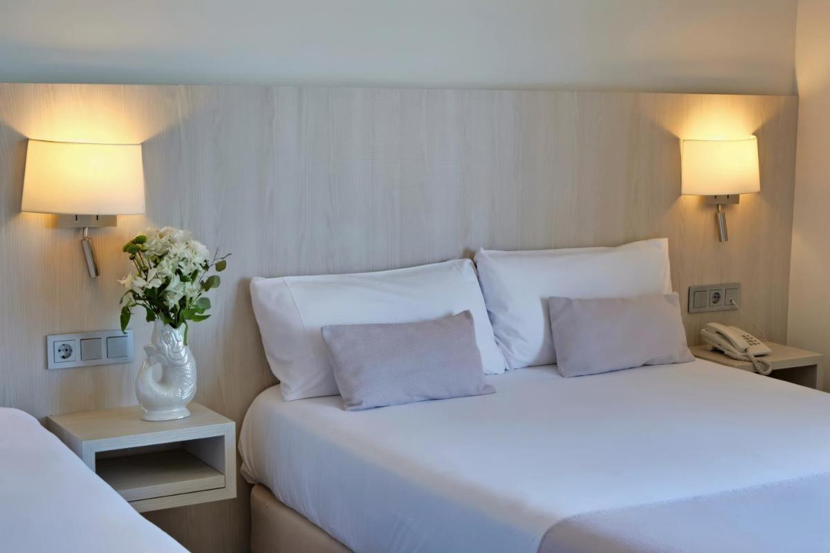Cama o camas de una habitación en Hotel Marina