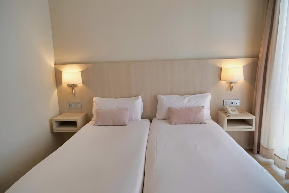 Cama o camas de una habitación en Hotel Marina