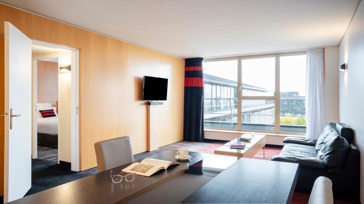 un salon avec un canapé et une table dans l'établissement Residhome Suites Paris Sénart, à Lieusaint