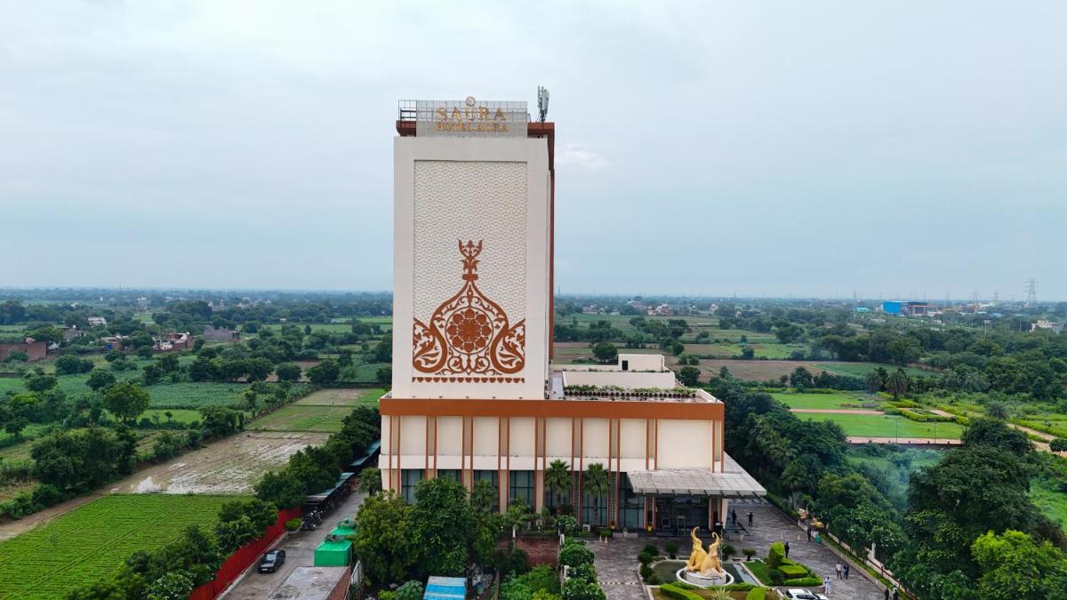 a building with a clock tower on top of it at Saura Hotel, Agra - A Club Mahindra Associate in Agra