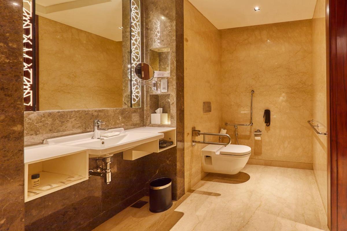 a bathroom with a sink and a toilet at Crowne Plaza New Delhi Rohini by IHG in New Delhi a bathroom with a sink and a toilet at Crowne Plaza New Delhi Rohini by IHG in New Delhi
