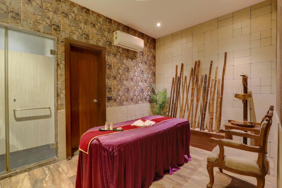 a room with a table and a chair in a room at Saura Hotel, Agra - A Club Mahindra Associate in Agra