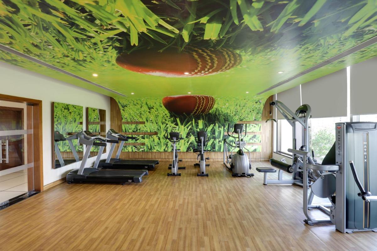 a fitness room with a gym with exercise equipment at Saura Hotel, Agra - A Club Mahindra Associate in Agra