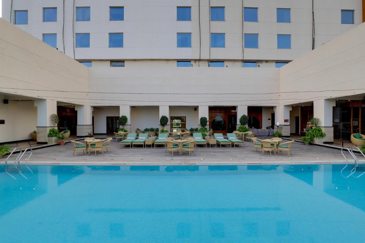 a view of the courtyard of a hotel with a pool at Saura Hotel, Agra - A Club Mahindra Associate in Agra