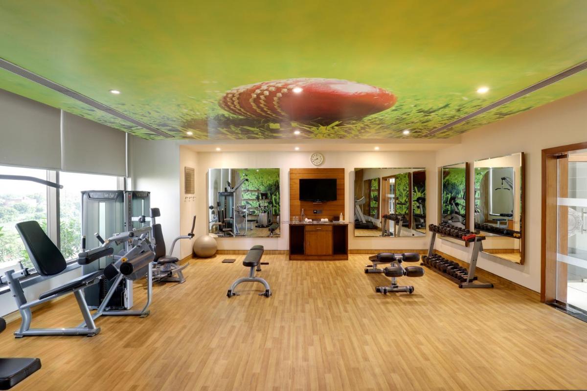 a fitness room with a gym with a ceiling with a fish on it at Saura Hotel, Agra - A Club Mahindra Associate in Agra