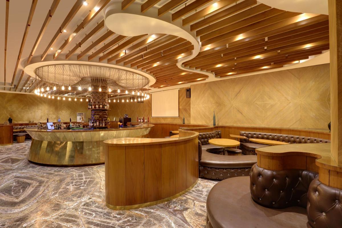 a lobby of a restaurant with a bar at Saura Hotel, Agra - A Club Mahindra Associate in Agra