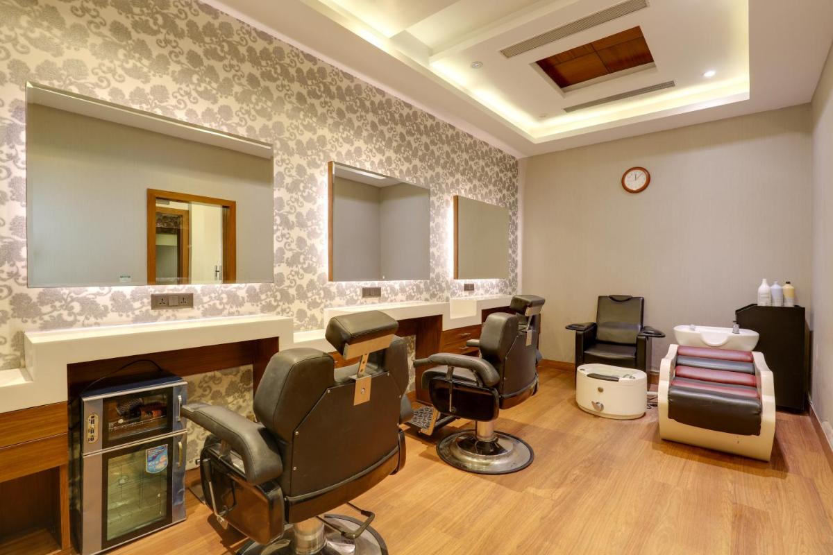 a salon with four chairs and a mirror at Saura Hotel, Agra - A Club Mahindra Associate in Agra