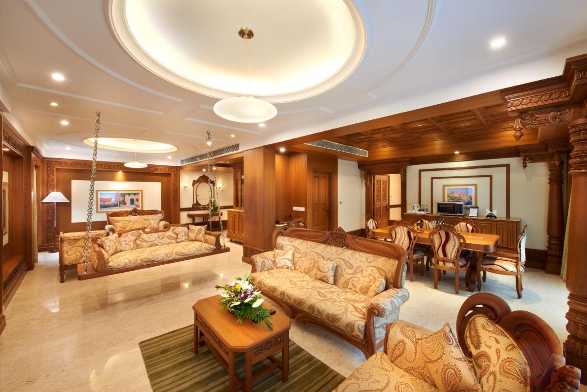 a large living room with couches and a dining room at Accord Puducherry in Puducherry