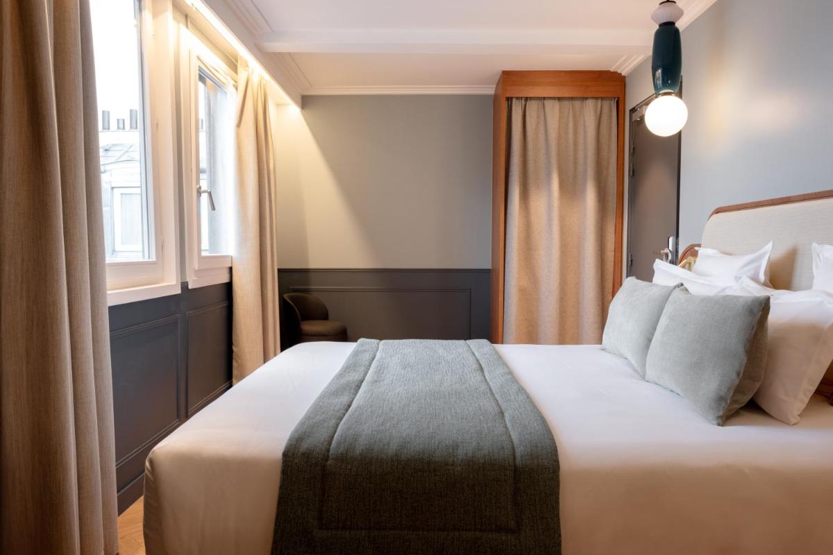 Un ou plusieurs lits dans un hébergement de l'établissement Grand Hotel Saint Michel