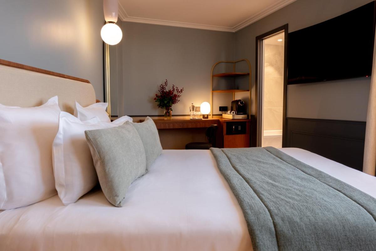 Un ou plusieurs lits dans un hébergement de l'établissement Grand Hotel Saint Michel
