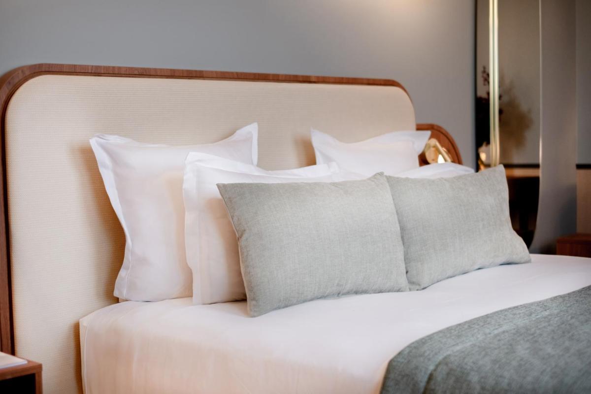 Un ou plusieurs lits dans un hébergement de l'établissement Grand Hotel Saint Michel