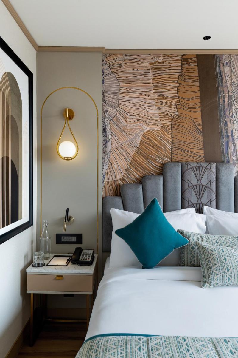 a bedroom with a large bed with a blue pillow at Parallel Hotel Udaipur, a member of Radisson Individuals in Udaipur
