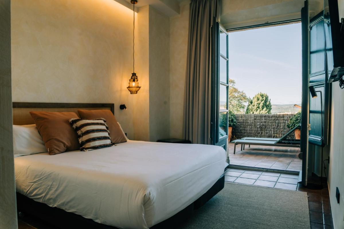 Cama o camas de una habitación en Gran Claustre Boutique Hotel