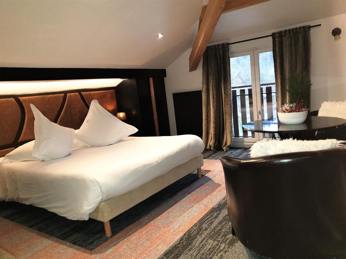 Un ou plusieurs lits dans un hébergement de l'établissement Domaine du Haut Jardin Hôtel & Chalets Spa Privé