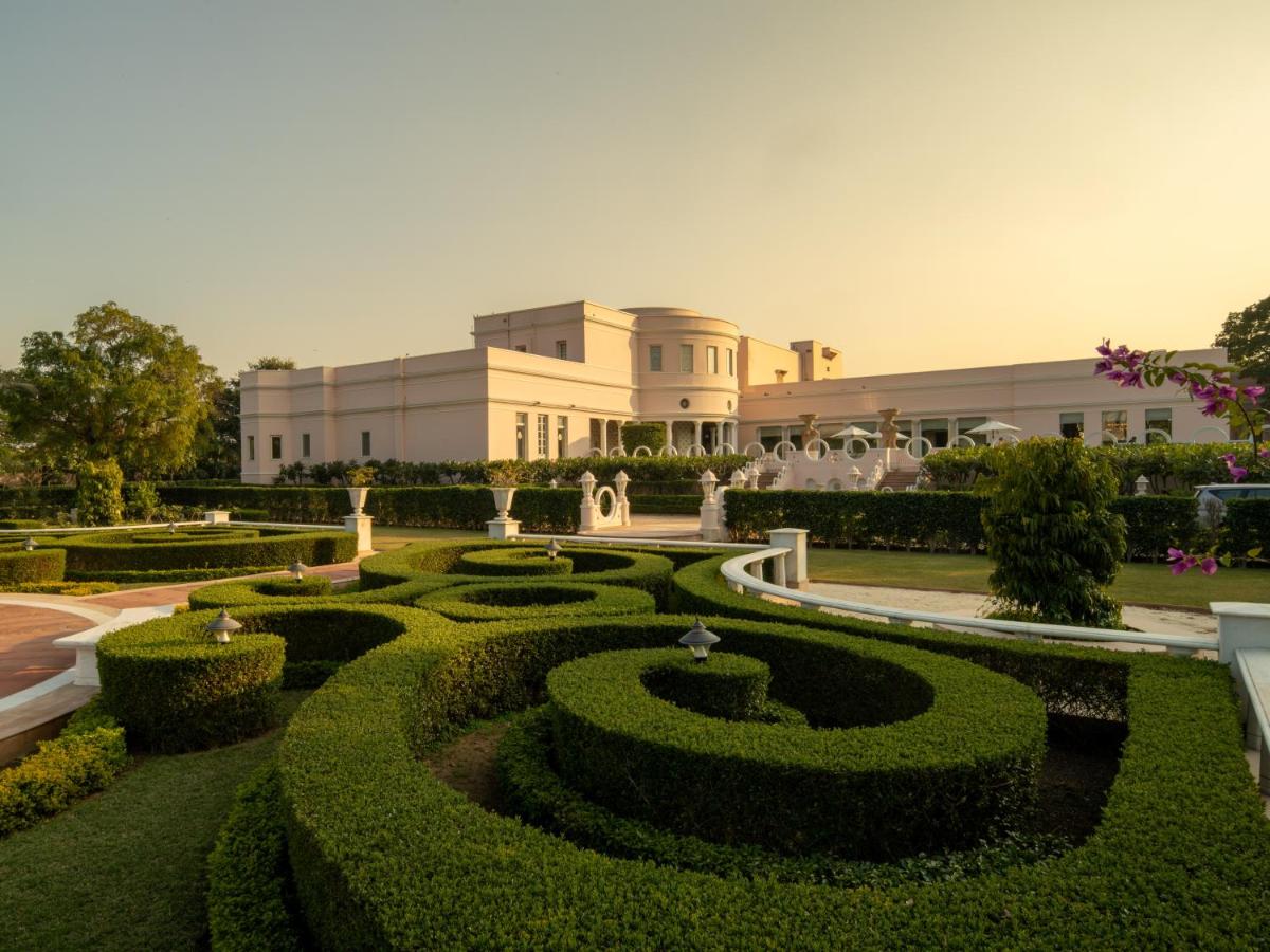 a garden with a building in the background at Rajmahal Palace RAAS in Jaipur