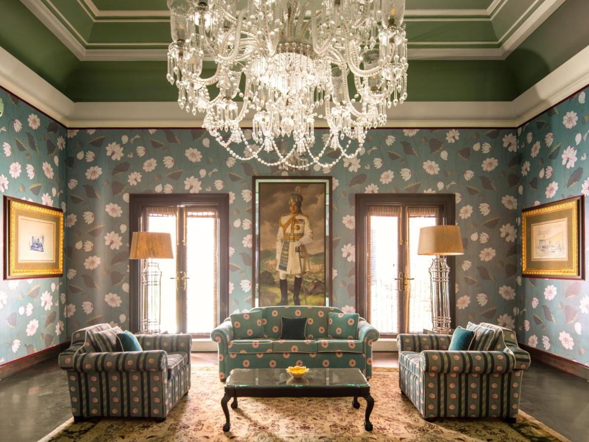 a living room with a chandelier and a couch and chairs at Rajmahal Palace RAAS in Jaipur