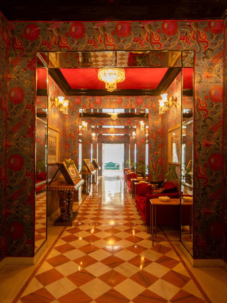 a hallway with a room with a checkered floor at Rajmahal Palace RAAS in Jaipur