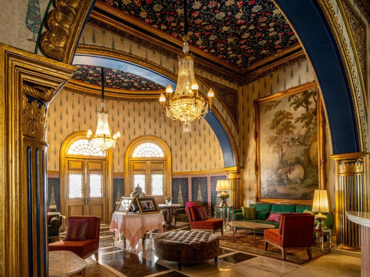 a living room filled with furniture and a chandelier at Rajmahal Palace RAAS in Jaipur
