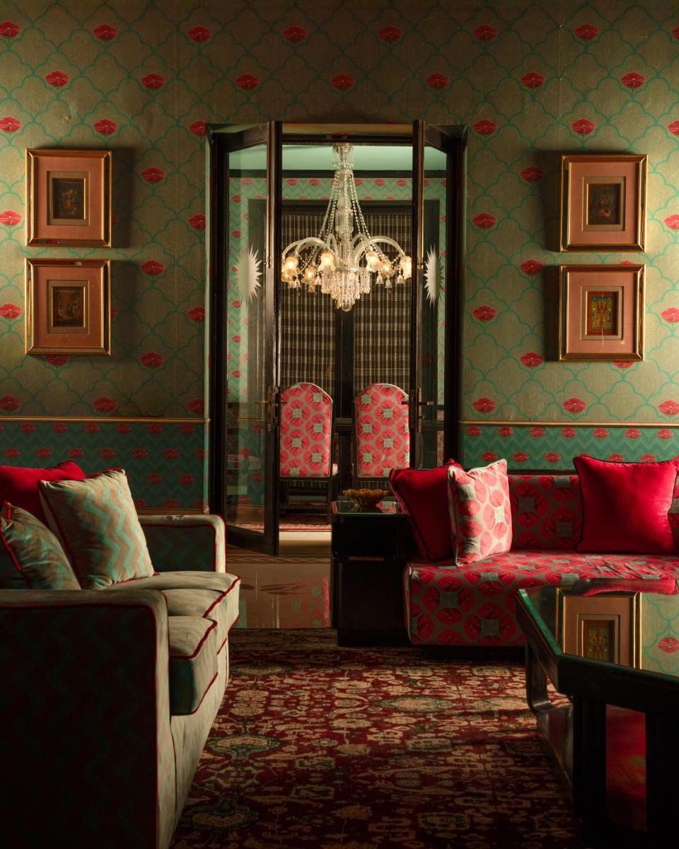 a living room with two couches and a chandelier at Rajmahal Palace RAAS in Jaipur